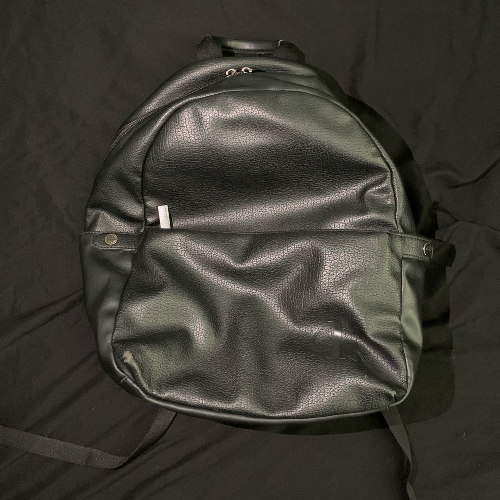 Calvin Klein Black Backpack with Rounded Design and Metallic Accents